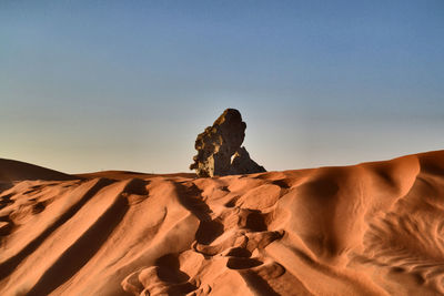 Rock formations in desert against clear sky