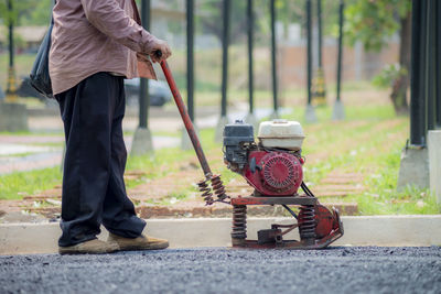 Low section of man working on road