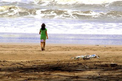 Rear view of man standing on beach