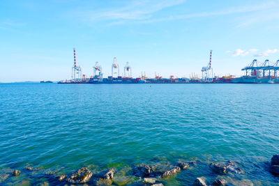 Commercial dock by sea against sky