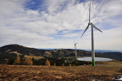 Windmill on field against sky