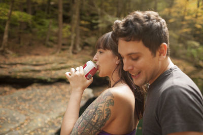 Side view of young couple kissing on land