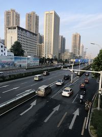 High angle view of traffic on road by buildings against sky