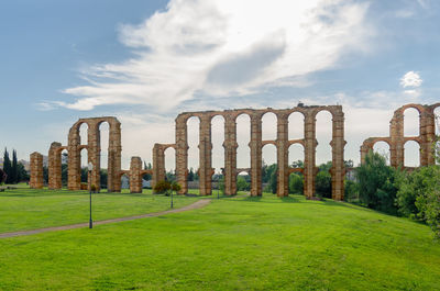 Built structure on field against sky