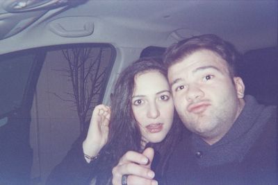 Portrait of smiling young woman in car