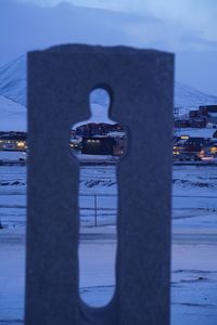 Close-up of illuminated city during winter against sky