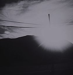 Power lines against cloudy sky