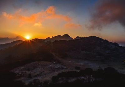 Scenic view of mountains against sky during sunset