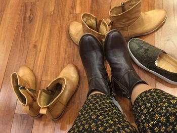 Low section of woman standing on hardwood floor