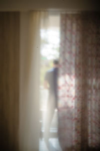 Rear view of woman walking through window