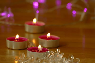 Close-up of lit candles on table