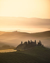 Scenic view of landscape against sky during sunrise