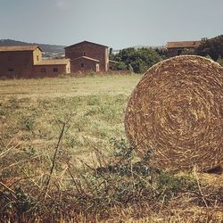 Hay bales on field against sky