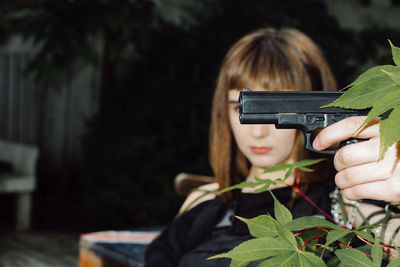 Serious woman holding gun