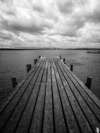 Pier over lake against sky