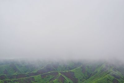 Scenic view of landscape against sky during foggy weather