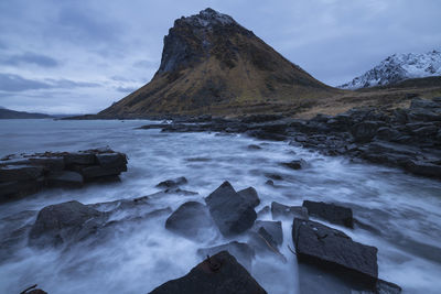 Scenic view of rocks in sea against sky