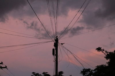 Low angle view of electricity pylon against sky