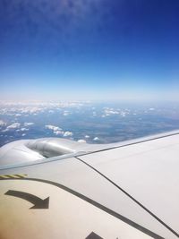 Aerial view of airplane wing against clear blue sky