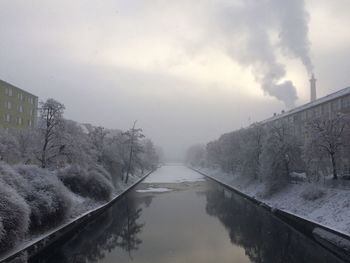 Snow covered bridge against sky during winter