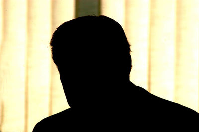 Close-up portrait of silhouette man standing against wall