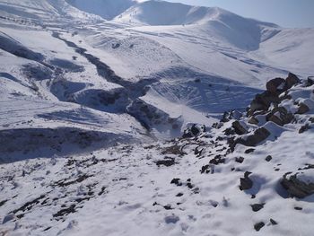 Scenic view of snow covered mountains against sky