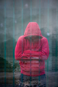 Close-up of woman sitting on wall