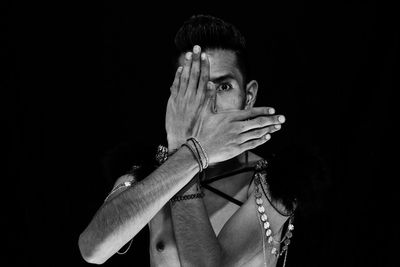 Close-up of person against black background