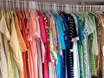 Close-up of multi colored clothes hanging at store