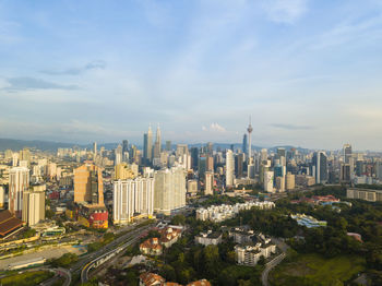 Petronas towers amidst cityscape against sky