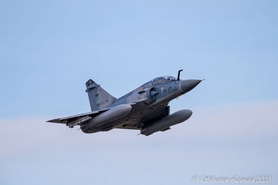 Low angle view of airplane flying against clear sky