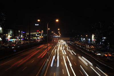 Light trails on road in city at night