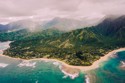 Aerial view of sea and mountains against sky