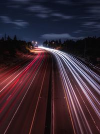 High angle view of light trails on highway at night