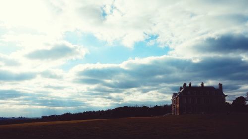 Scenic view of landscape against cloudy sky