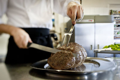 Midsection of man preparing food