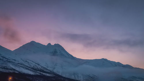 Scenic view of snowcapped mountains against sky during sunset