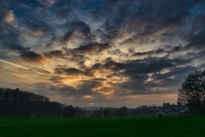 Scenic view of field against sky during sunset