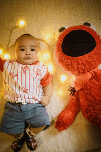 Low section of woman standing by christmas tree trunk