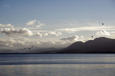 Calm lake against mountain range