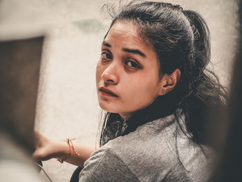 Portrait of young woman sitting outdoors