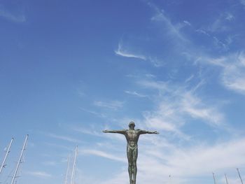 Low angle view of statue against blue sky