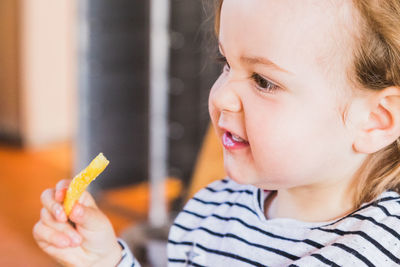 Close-up cute girl eating french fries