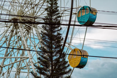 Low angle view of ferris wheel against sky