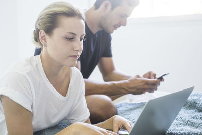 Midsection of couple working at home