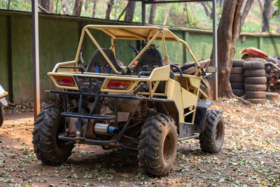 A yellow buggy is parked.