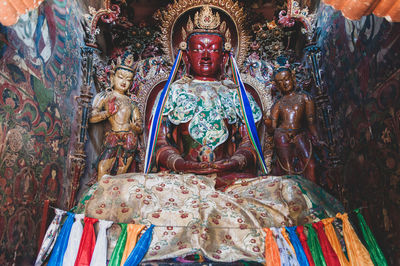 Statue of buddha against building