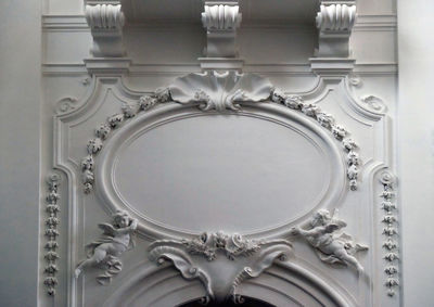 Directly below shot of ornate ceiling in building