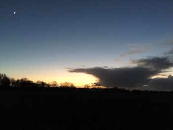 Silhouette trees against sky during sunset