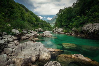 Scenic view of rocks and trees against sky